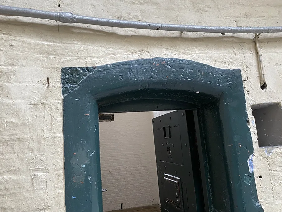 No Surrender Carved in stone over a cell doorway in Kilmainham Gaol.