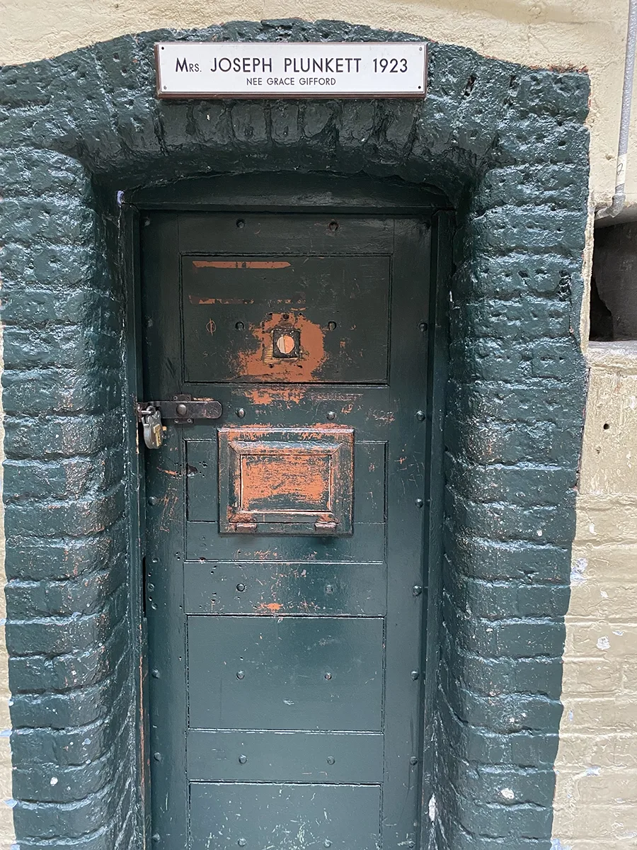 Jail cell with the the name Mrs. Joseph Plunkett over the door.