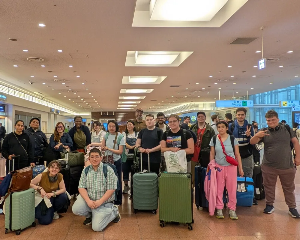 A group of students and their luggage at an airport.