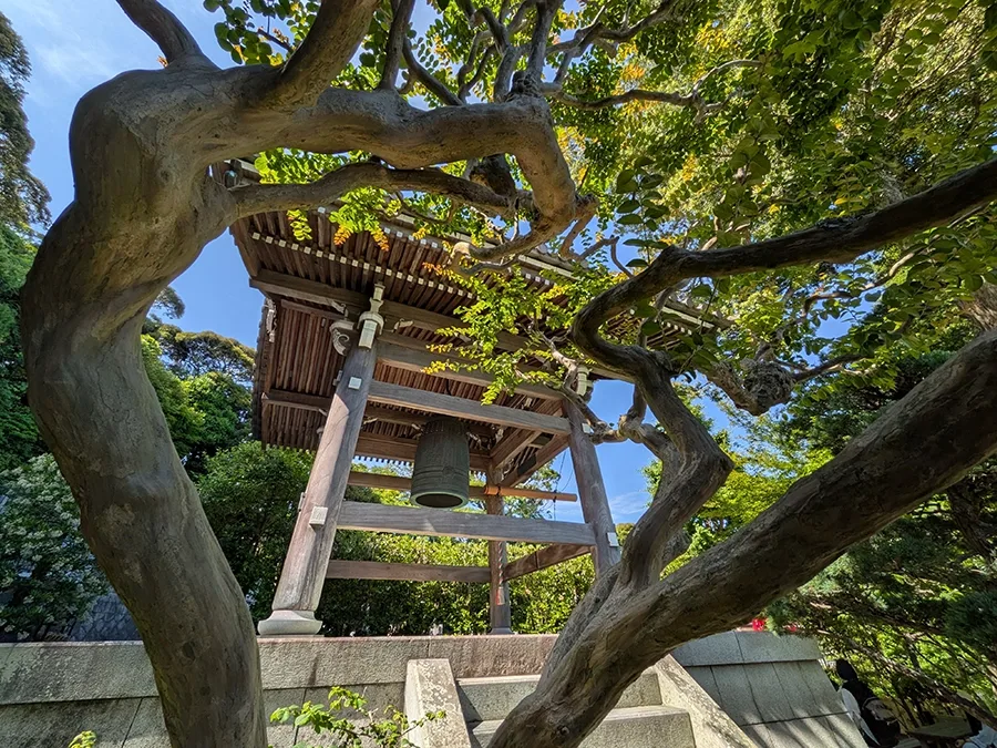 Upwards view of a wooden structure with a bell.