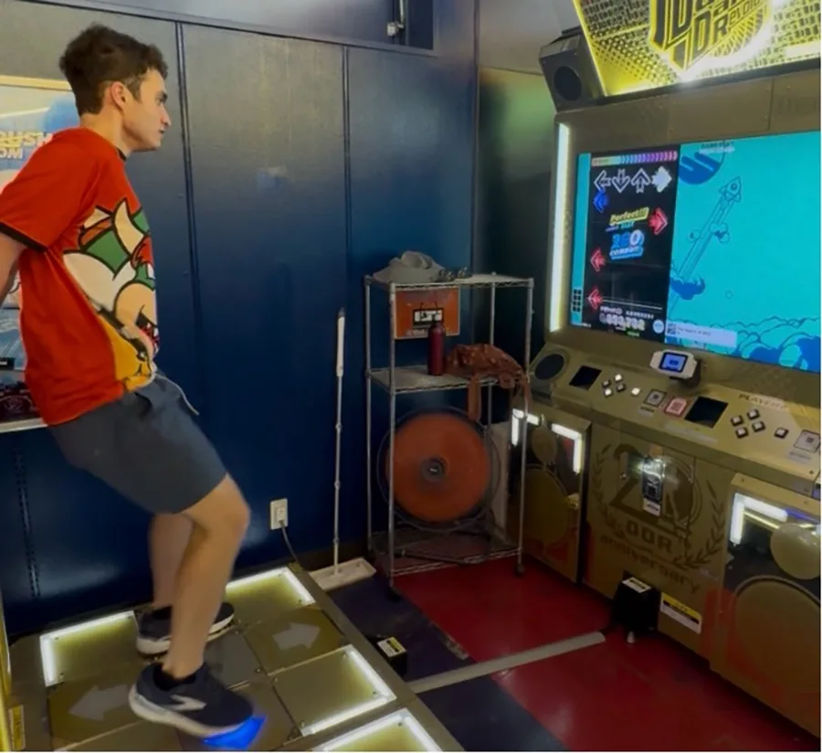 A person plays a rhythm video game called The Legend of MAX.