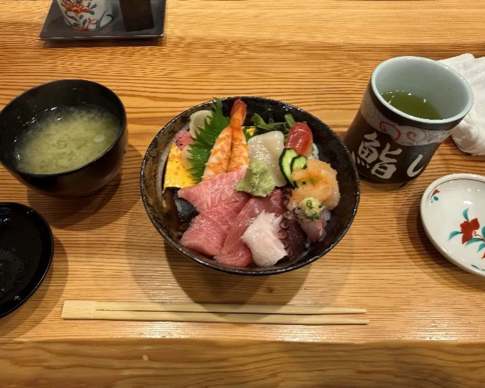 A Japanese meal consisting of sushi, soup, and tea.