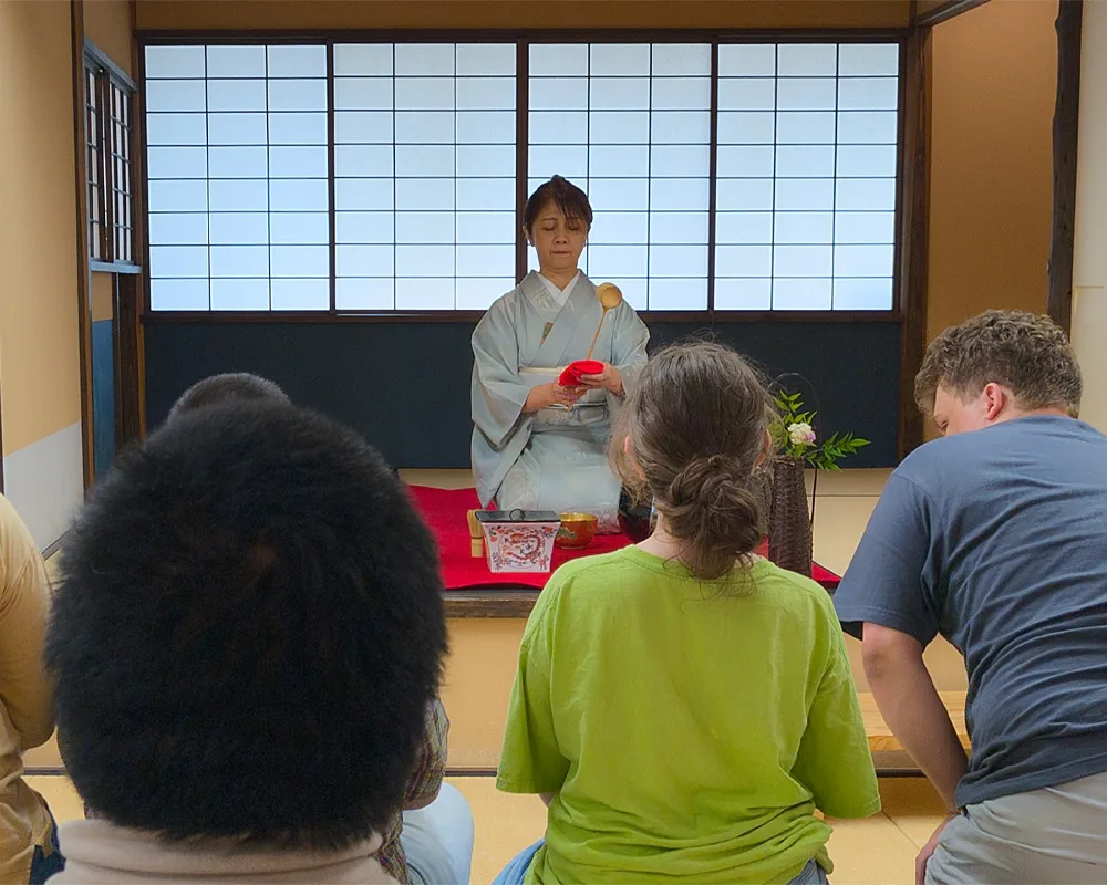 A woman in a kimono leads a Japanese tea ceremony.