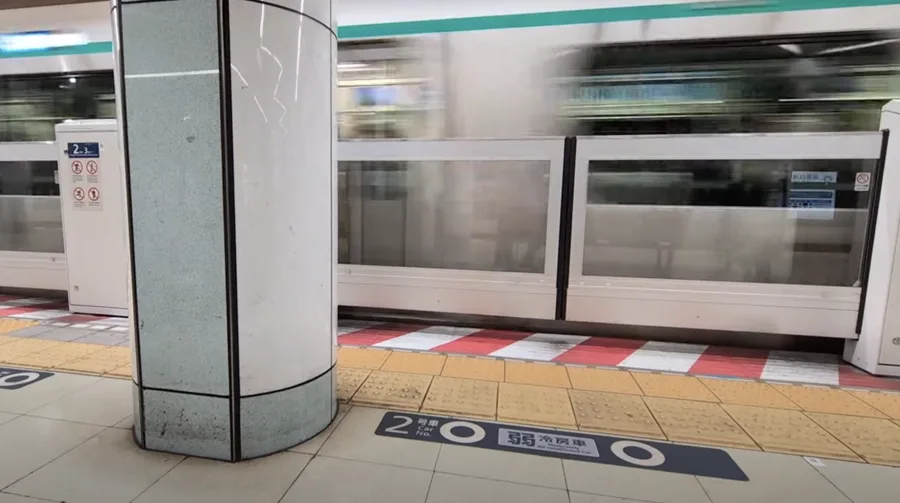 A fast moving subway train appears as a blur as it arrives in the station.