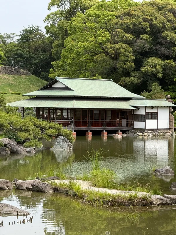 Japanese Tea House juts out over water.