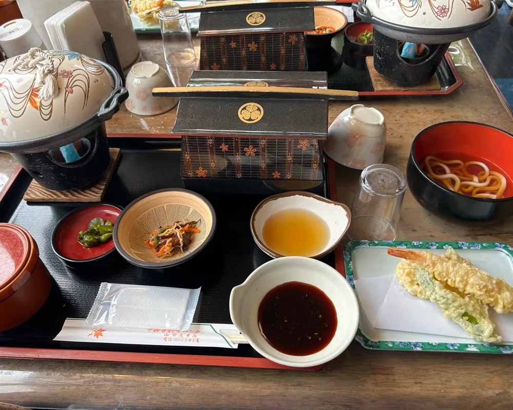 A traditional Japanese meal including tempura and noodles.