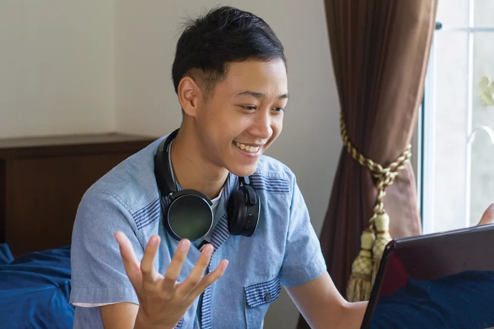Male student on a laptop.