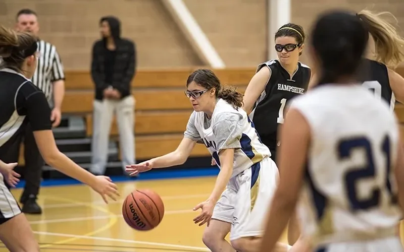LC women's basketball player dribbling the ball down court.