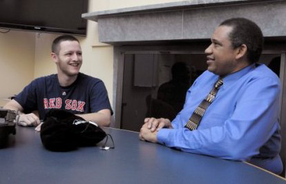 Everett Law having a conversation with a man in a blue shirt and tie