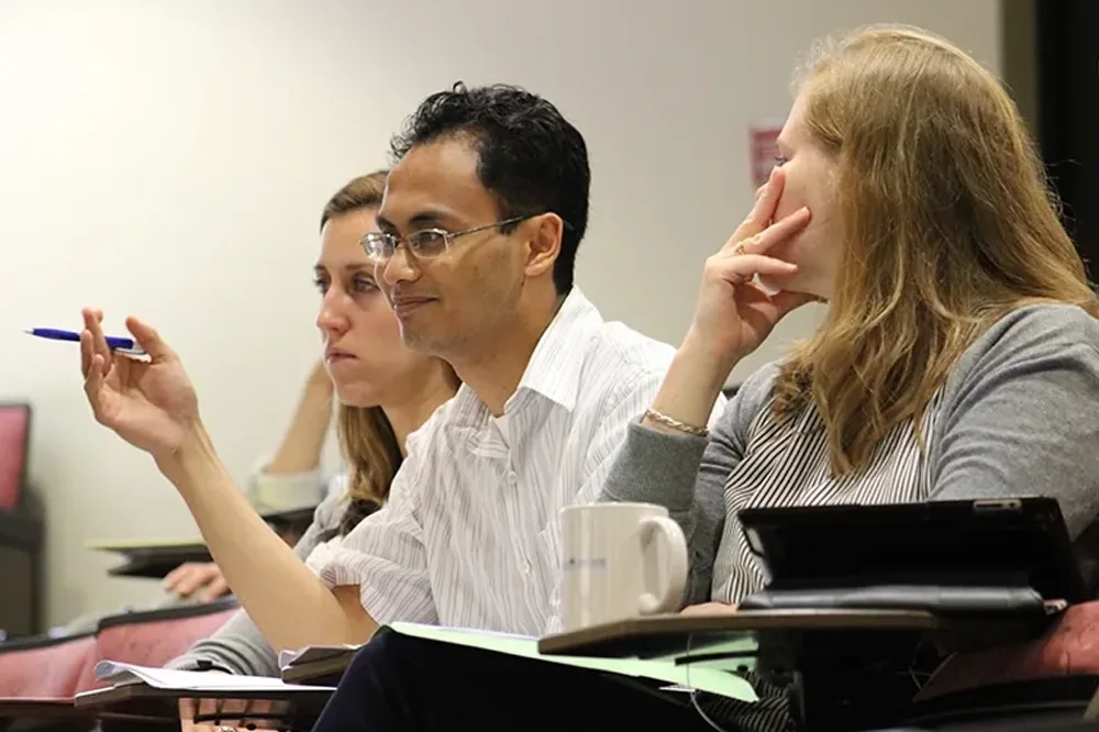 Three people attending a summer institute session.