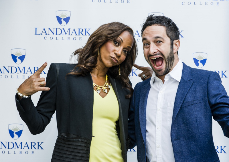 Holly Robinson Peete gestures and stands next to Aaron Wolf, who has an exuberant smile; Landmark College logo in background.