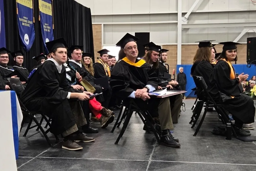 Bretton Himsworth '90 sitting with his honorary degree