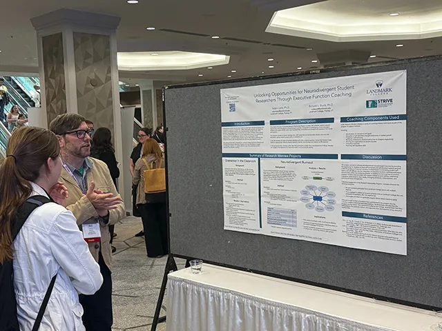 Dr. Rick Bryck standing with a conference participant in front of a poster.