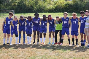 Landmark Men's Soccer team posing for a photo on field.