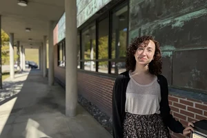Gabrielle Ewall standing outside of the STEM building on campus.