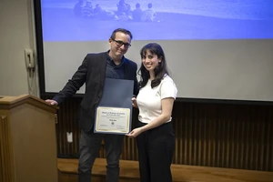 Professor Ryan Ware presents student Talia Katz with the Rob Gunther-Mohr Award in Spring 2025