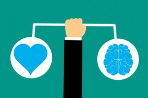 Drawing of an arm holding up a scale with a heart on one side and a brain on the other.