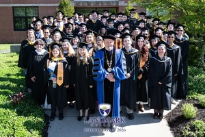 The spring 2026 graduating class standing outside of the Click Center.