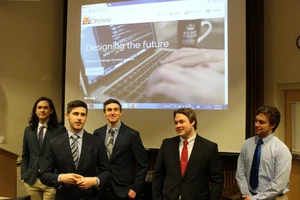 Five recipients of LEAP grant for Ohmnii stand in front of projector screen that says Designing the future.