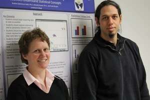 Bower and Dahlstrom-Hakki with a poster behind them.
