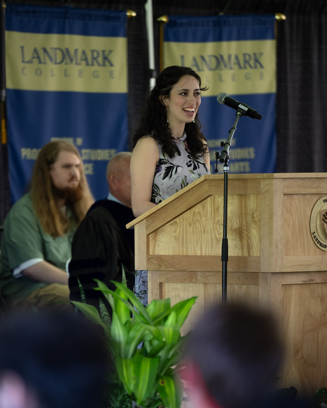A student speaking into a microphone at the podium