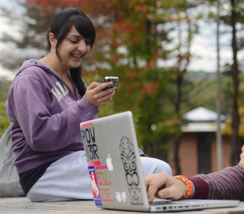 Student looking at her smartphone.