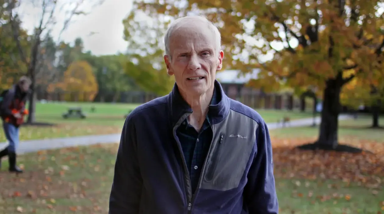 Jim Baucom standing on the Landmark College quad in autumn.