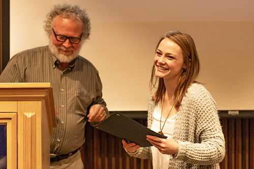 Burgess handing Loveland her award.