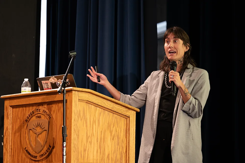 A person stands at a podium while giving a presentation.