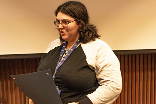 Rinehart holding an award.