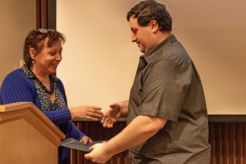 Hinckley handing Hadjiyane his award.