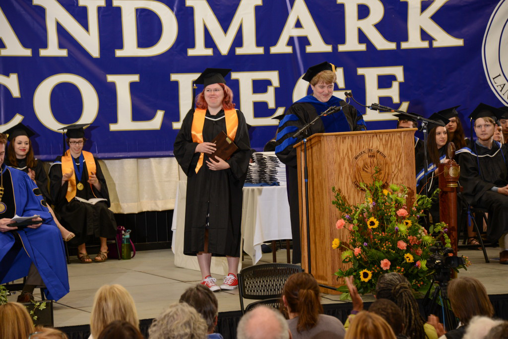 Molly Nelson at podium with Gail Gibson on graduation stage.