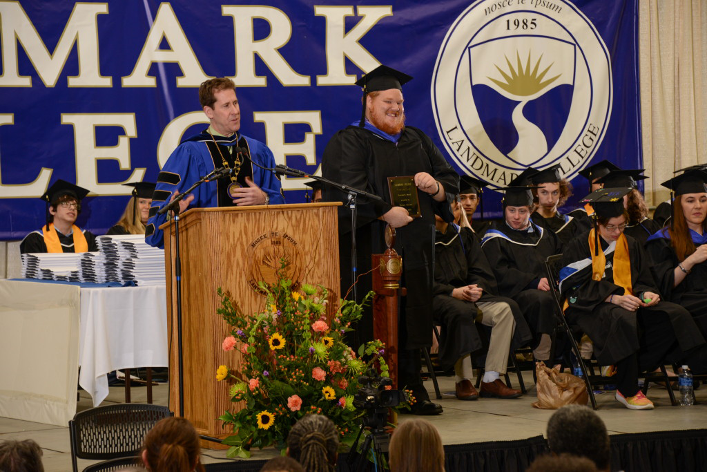 Michael Kenyon at podium with Peter Eden on graduation stage.