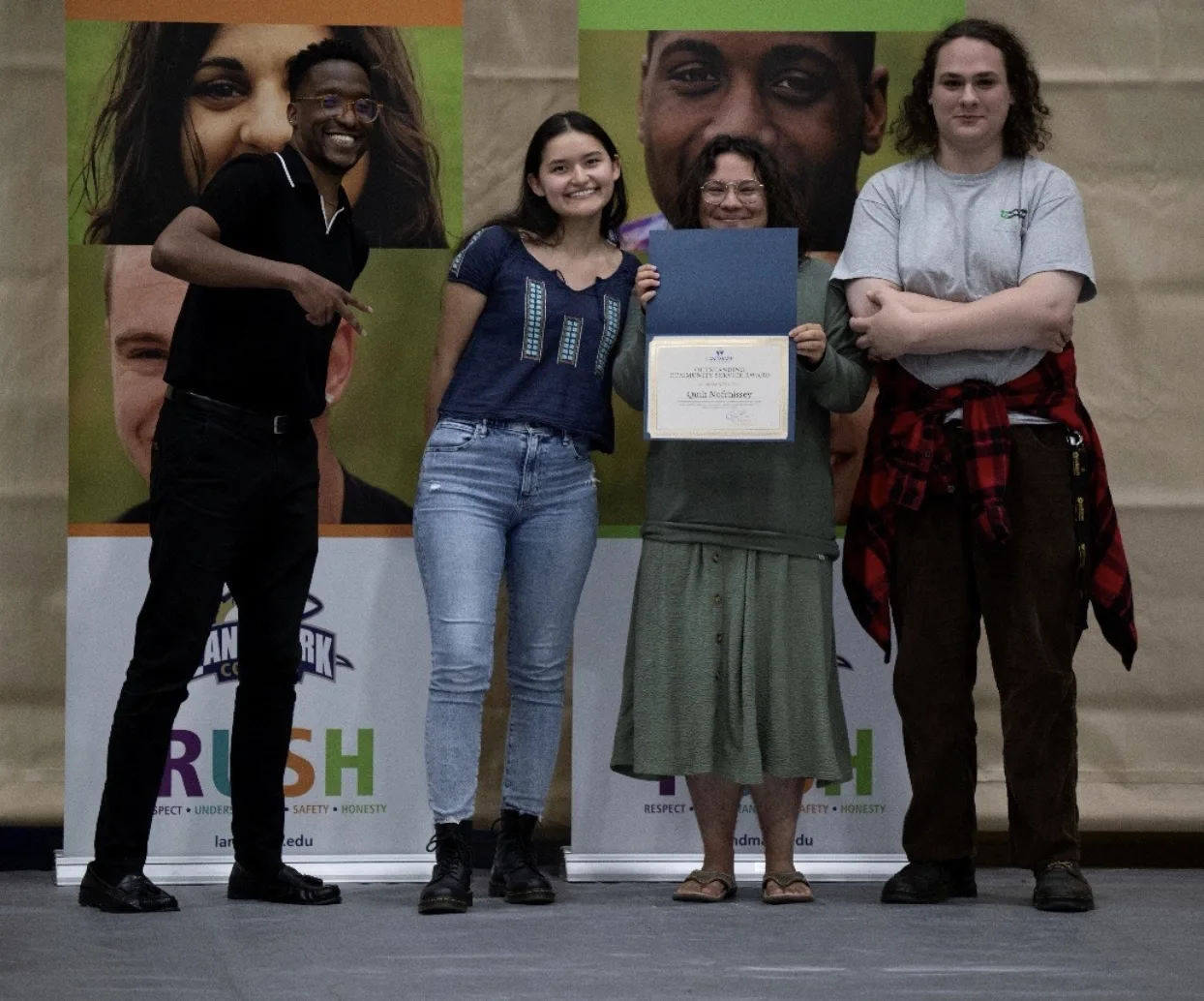 Quilt Nofchissey holding her award with presenter Marc Thurman, Karina Alaniz to the left, and Max Dehais.