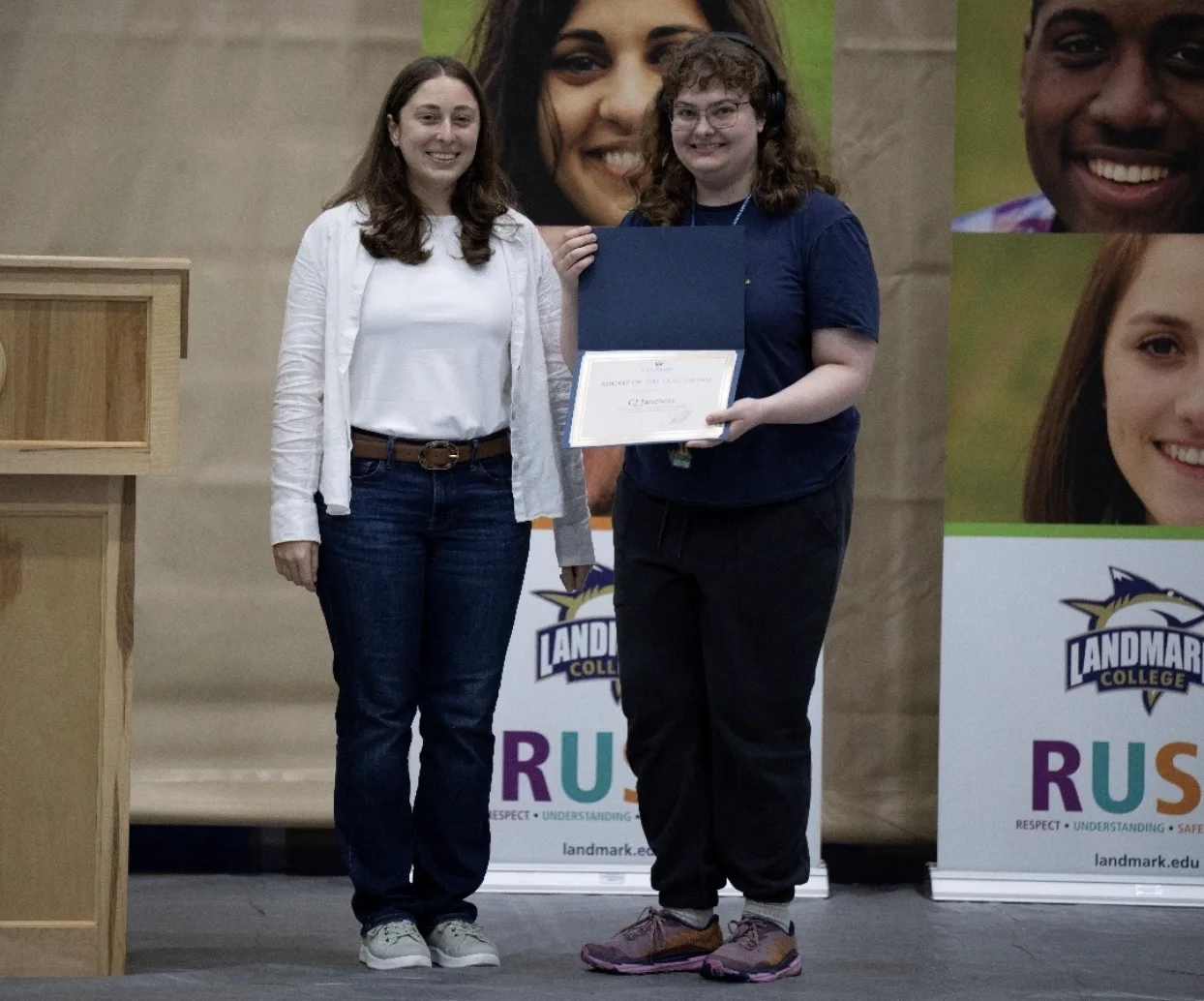 CJ Janeway holding her award next to presenter Yasmin Aragona on the left.