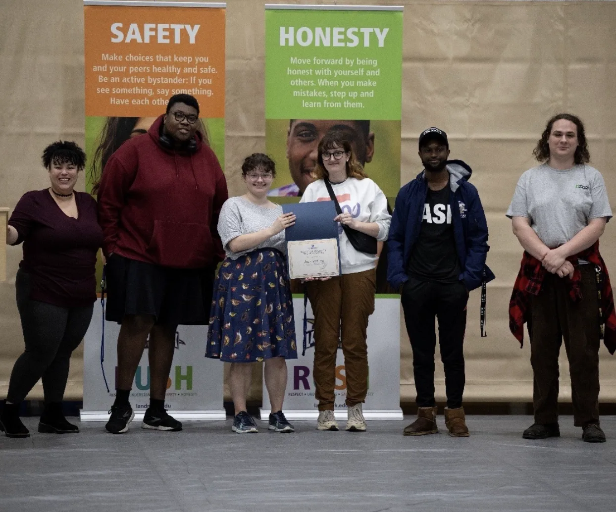 A group of students accepting the Social Program of the Year Award.