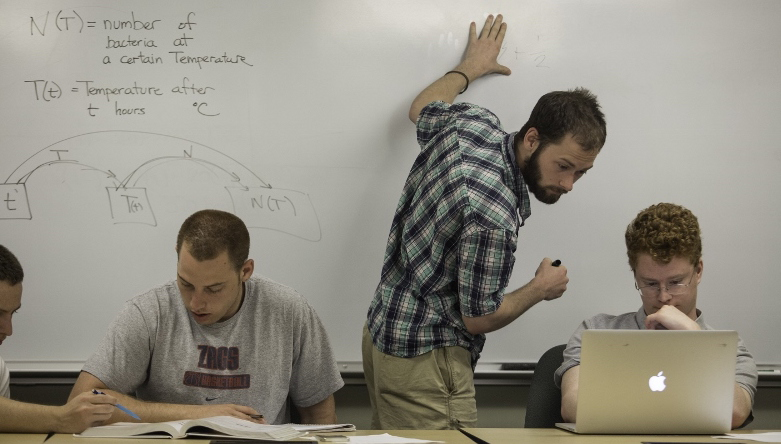 4 Landmark College students working together on math problems.