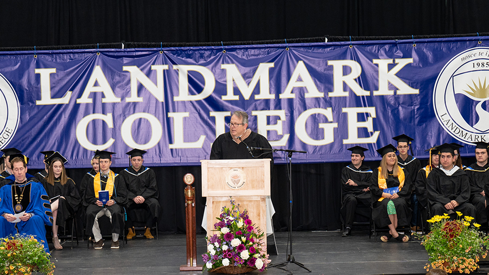 Michael Luciani giving a speech at the podium.