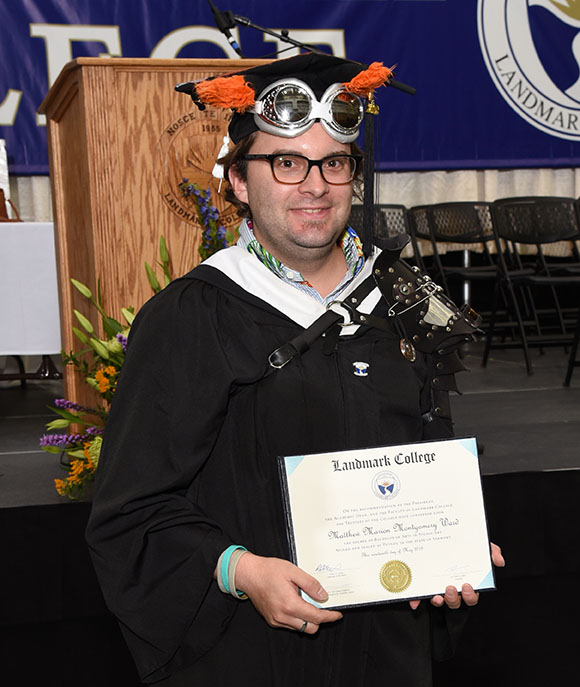 Matthew Ward holding his diploma.