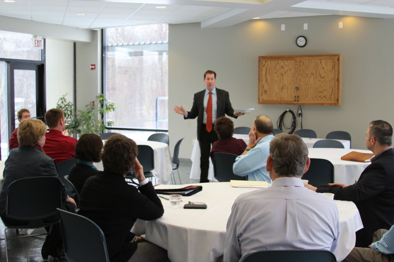 Peter Eden gestures and talks to group in Cafe Court.