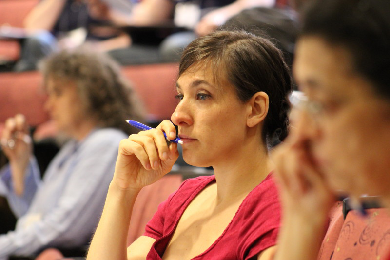 Summer Institute attendee wearing a red shirt in the audience.