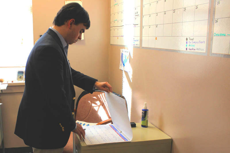 William Epifanio looking through a calendar.